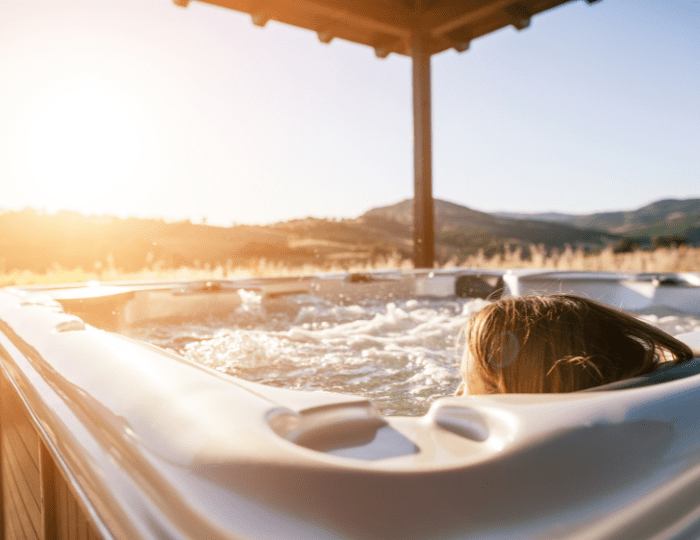 A person in the hot tub with sun shining on it.