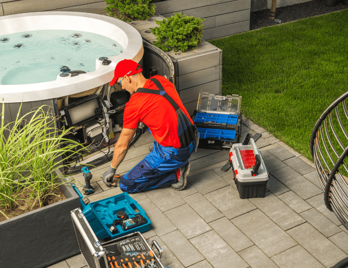 A man in red shirt fixing a hot tub.